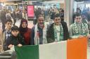 Zac Hania (centre) is reunited with his family at Dublin airport (Freda Hughes/PA)