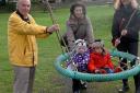Martin Harwood, Vanessa Lawrence and Roz Capps with her children Isobel and Oscar on one of the new pieces of play equipment at Walnut Tree Field in Fairford