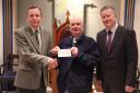 Charles Perkins, left, master of the lodge, presents the cheque to George Hill