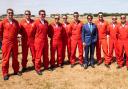Tom Cruise (in a blue suit) with the famous Red Arrows pilots. Image: RAF Red Arrows