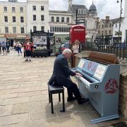 Reverend Canon Graham Morris treating the audience to some great music at the unveiling of the new street piano in Cirencester