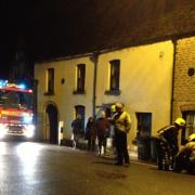 Firefighters prepare to pump out a house in Malmesbury last night