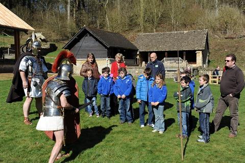 Visiting school children watch a demonstration of Roman battle techniques 