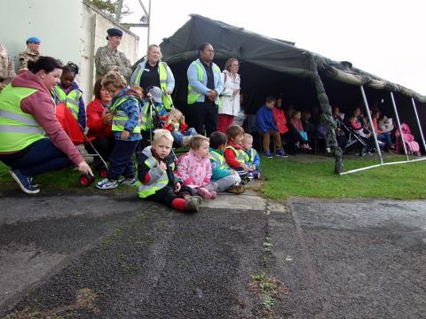 Families of the returning troops watch the parade