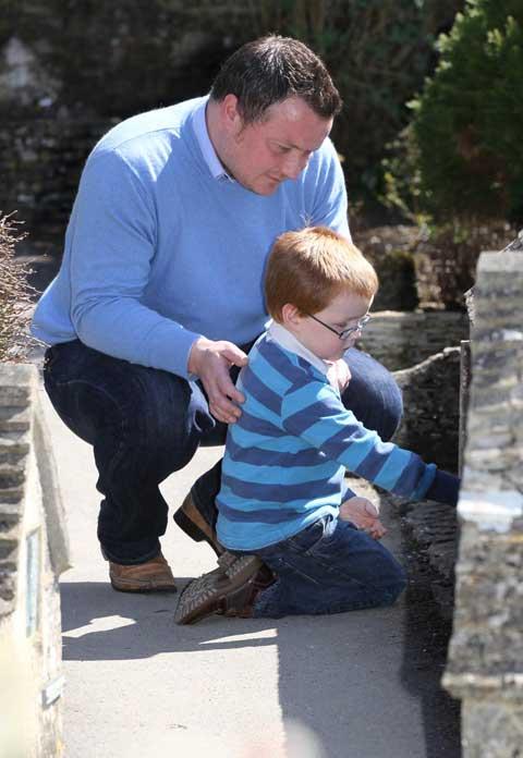 Adam Law, with his son James, from Corsham looking at the Carrick Travel shop at Bourton Model Village.