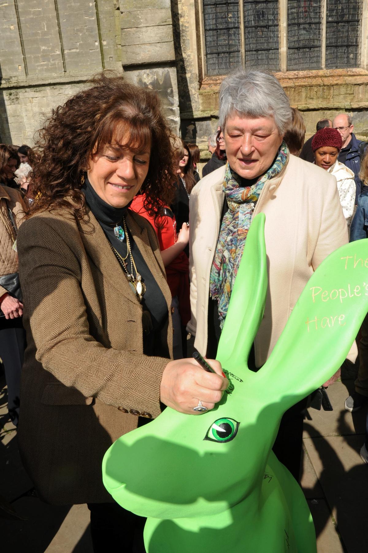 Countess Bathurst and the Lord Lieutenant for Gloucestershire Dame Janet Trotter sign the People's Hare at the launch of the Hare Festival in Cirencester 
