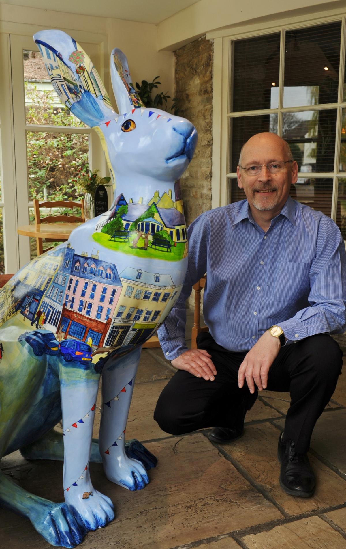 Tim Waller, proprietor of the Corinium Hotel in Gloucester Street, with Corinna the hare by artist Laura Fearn