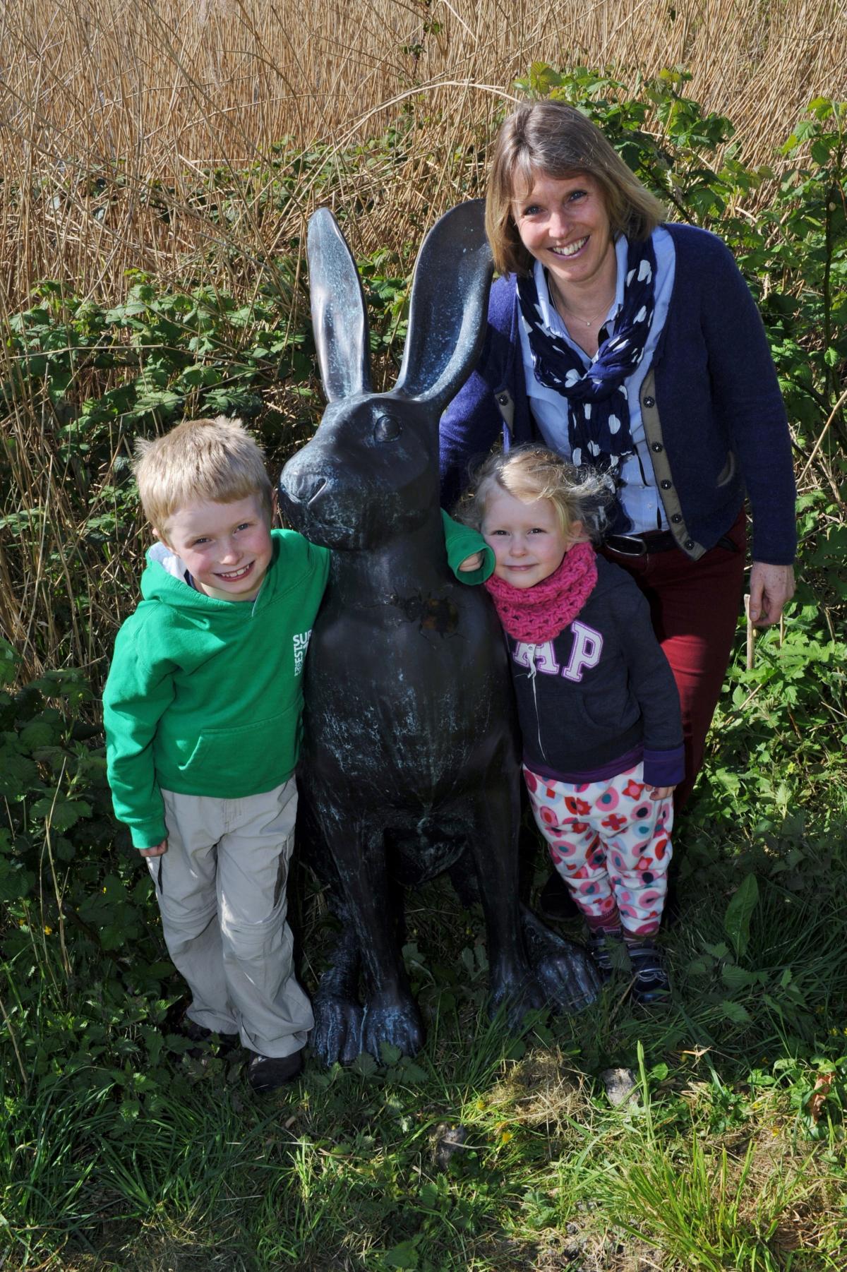 Jill Bewley, Communication and Events Manager at Cotswold Water Park shows visitors Thomas, 6, and Heidi Weeks, 4, the new hare by TV presenter Ellie Harrison at the Gateway Centre