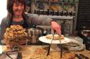 Karen Harvey serving cakes at Diversitea Café in Cirencester