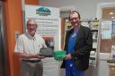 Malmesbury League Of Friends chairman David Hide handing over two items of medical equipment to Dr Tom Estcourt