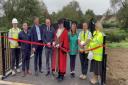 Malmesbury mayor Cllr Gavin Grant cutting the ribbon at the opening ceremony of the new footbridge