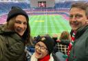 Sophie Delaney (left), her husband Andrew (right), and their son Joey (centre), at the Wales vs Australia game