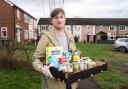 Harry Lay with a foodbank package