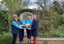 Mel Tanner, owner of The Coach House, Ampney Crucis, Cirencester receives a long service certificate and trowel to mark 10 years of opening her garden for the National Garden Scheme from Vanessa Berridge, County Organiser for Gloucestershire. Sarah