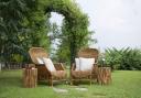 Two garden seats in front of an arch. Credit: Canva