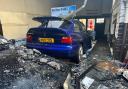 Aftermath of blaze at Hyams Autos with smashed windows, debris and rubble