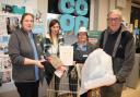 Co-op staff Helen and Gill join Ruby Blaken and Gavin Grant at the clothing donation box at the front of the store