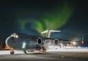 Royal Air Force C-17, ZZ175, on the deck at Bardufoss Airbase with the Northern Lights shining above, and was taken by Lee on December 2, 2022