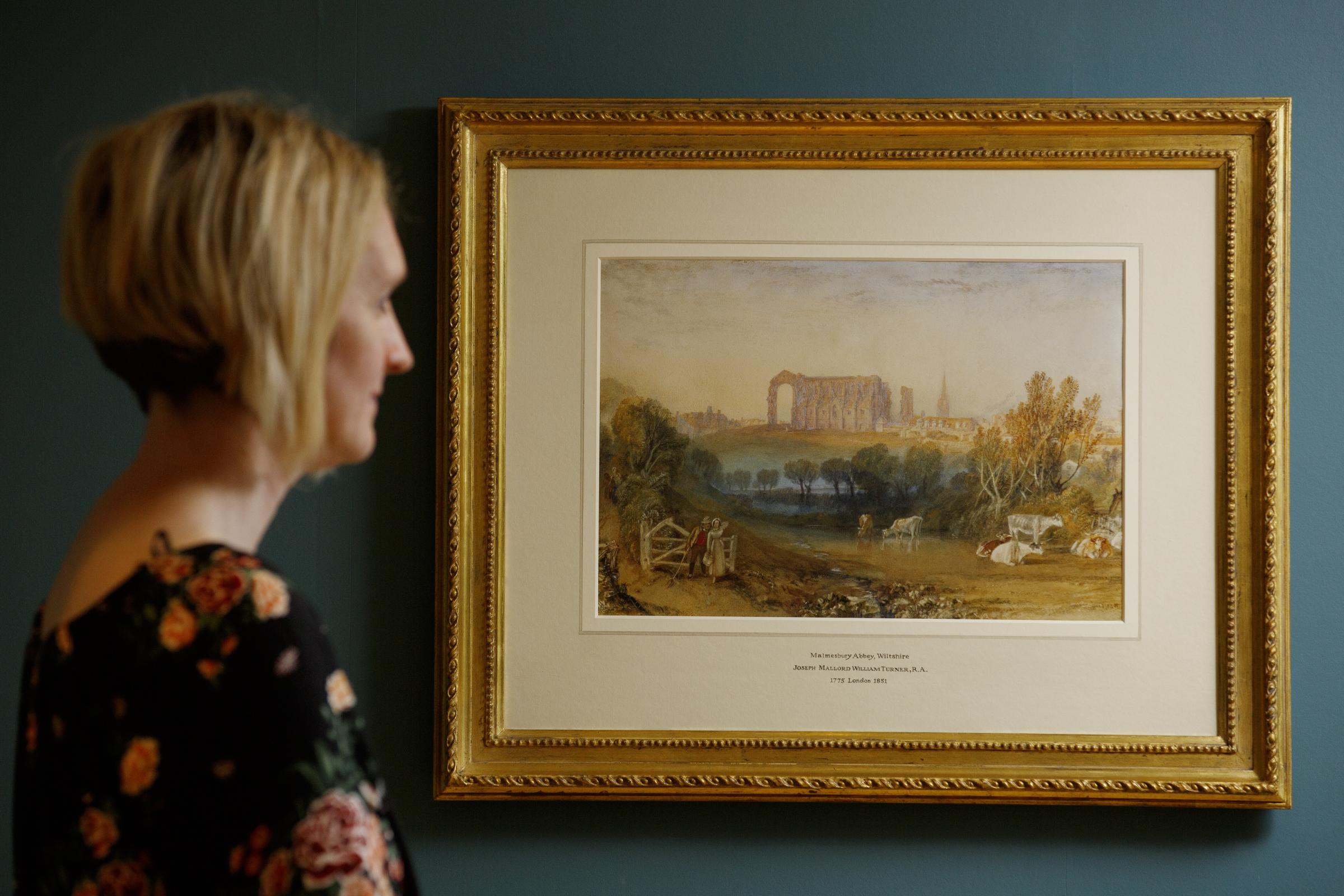 The Mayor’s secretary, Lynda Cryer, views the painting of “Malmesbury Abbey, Wiltshire” by British artist J.M.W. Turner on public display, for the first time in 200 years, at the Athelstan Museum and Gallery Photo by Luke MacGregor