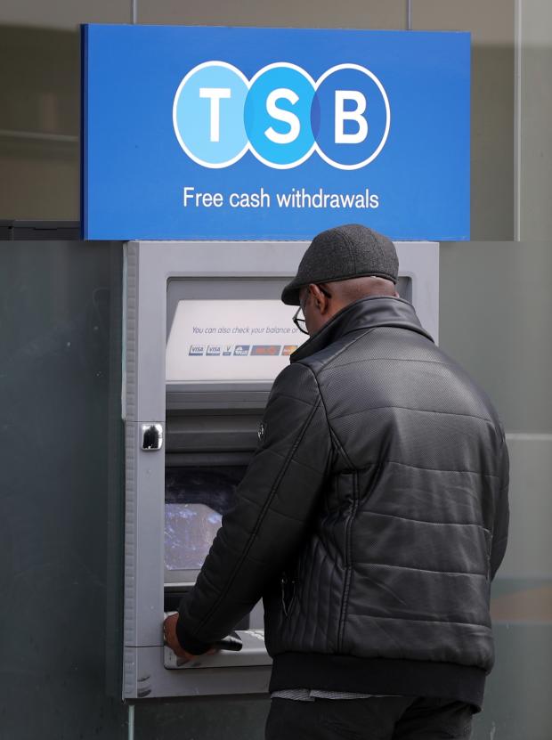 Wilts and Gloucestershire Standard: A man uses a TSB cash machine in Ashford, Kent (Gareth Fuller/PA)
