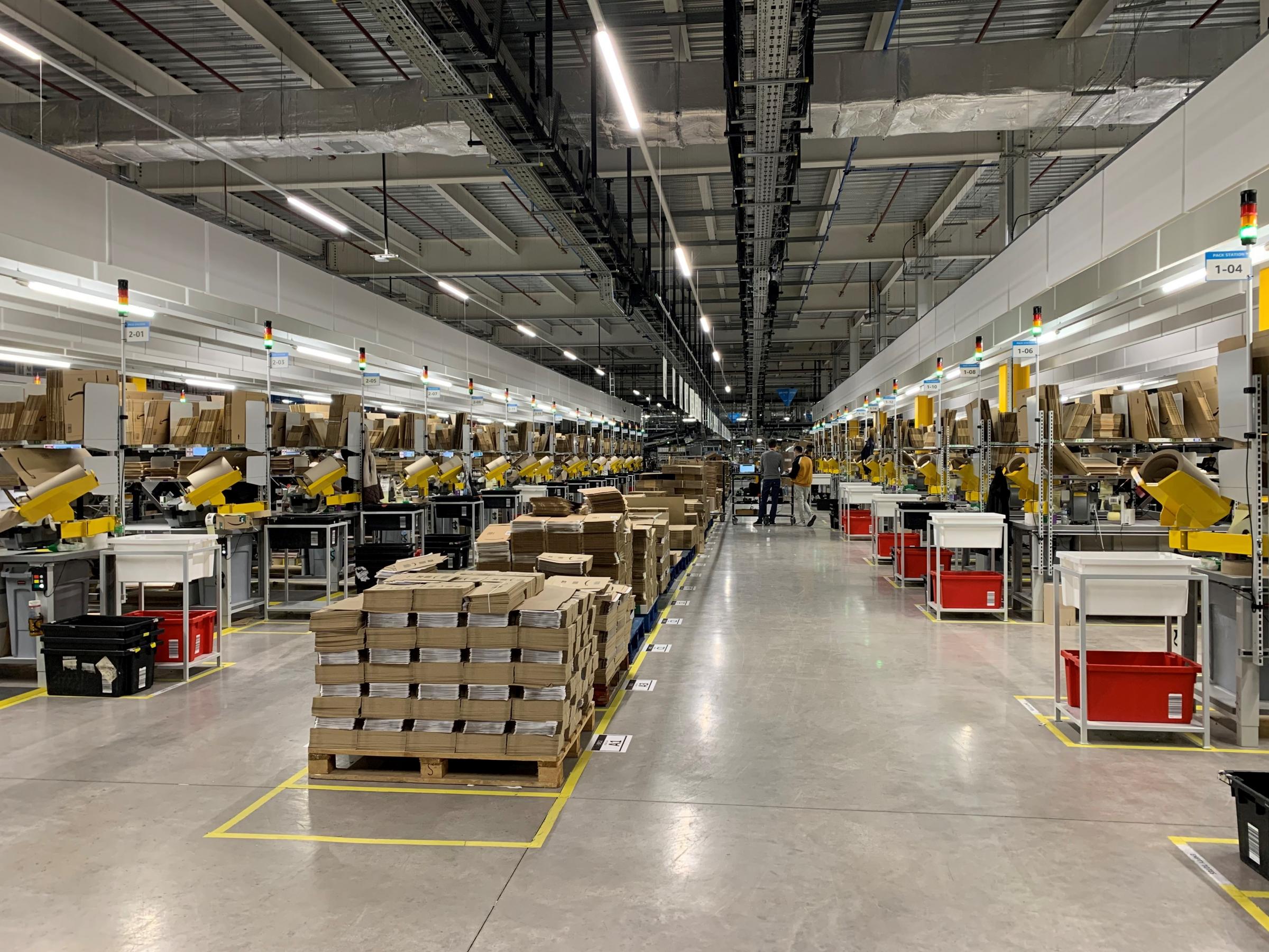The newly-packaged Amazon orders sorted throughout the fulfilment centre warehouse are placed onto the conveyor belt to be sent to delivery centres