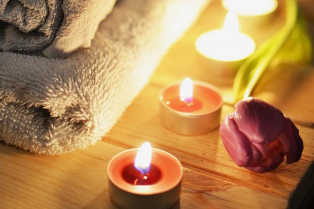Wilts and Gloucestershire Standard: A pile of towels, candles and a tulip. Credit: Canva