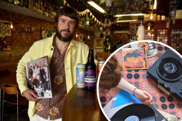 The Record Cafe's Keith Wildman, pictured left, in his popular music shop and bar. Inset, someone listens to music on a record player. Source: Newsquest/Natasha Meek.