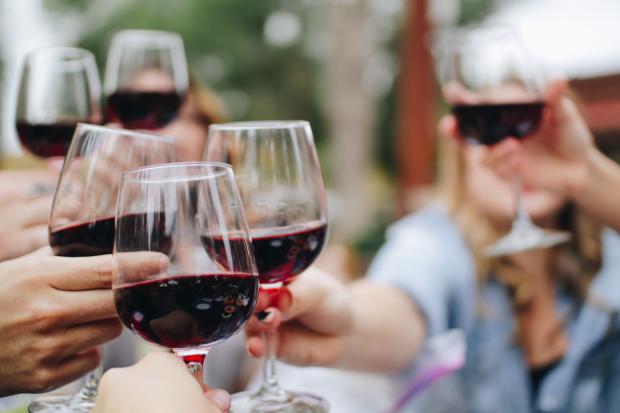 Wilts and Gloucestershire Standard: People making a toast with glasses of red wine (Canva)