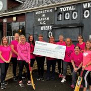 Moreton-in-Marsh ladies cricket team receiving a £1000 cheque from Persimmon Homes Wessex. 