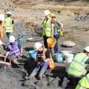 Palaeontologists excavating a mammoth tusk found at the Hills Quarry site