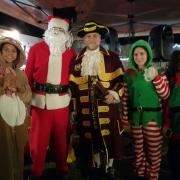 Fairford town crier Andrew Stopka with Santa Claus, elves and a reindeer
