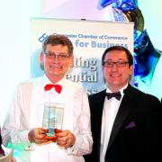 Roger Brown receives his award at the Cirencester Chamber of Commerce awards