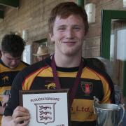 Thornbury's Harry Tarling with the Development League Cup and plaque