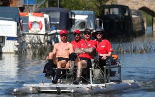 Alex Gibson (left), a GB decathlete who was diagnosed with Motor Neurone Disease four years ago, leads his team of Challenging MND fellow hydro-pedallers (second left to right) Andy Long, Joe Reed, and Alun Thomas, as they travel along the River Thames