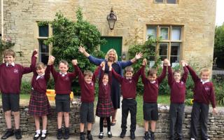 Pupils with headteacher Suki Pascoe celebrating the Ofsted result at Bibury Primary School