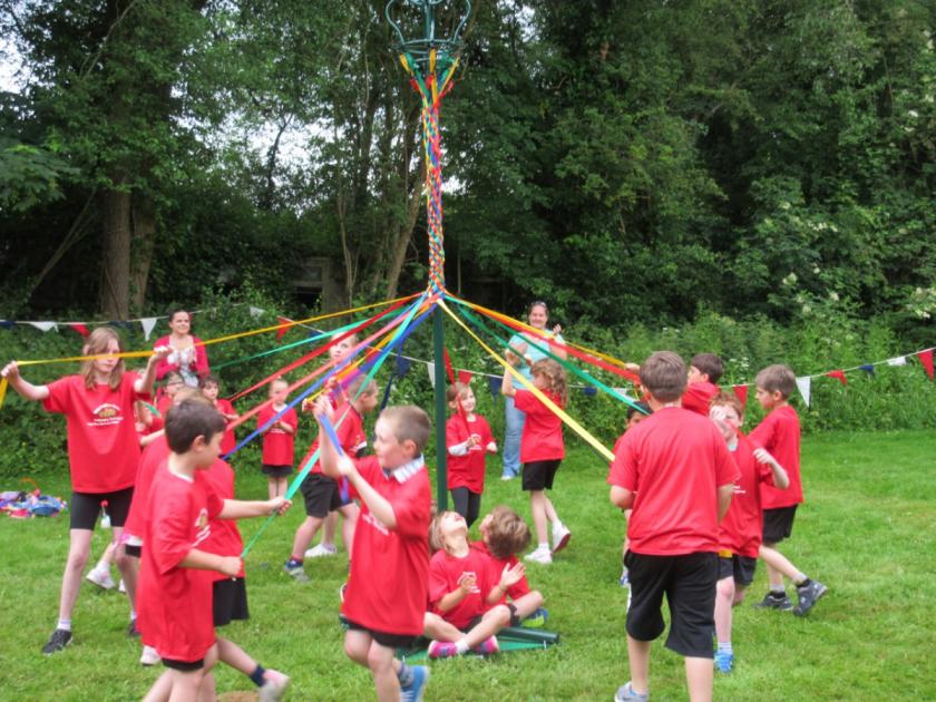 Children at Withington Primary School enjoy village fete with parade and maypole dances 